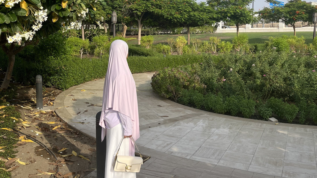 Light Puprle hijab styled with a purple blouse and white skirt.