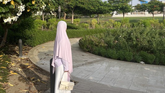 Light Puprle hijab styled with a purple blouse and white skirt. 